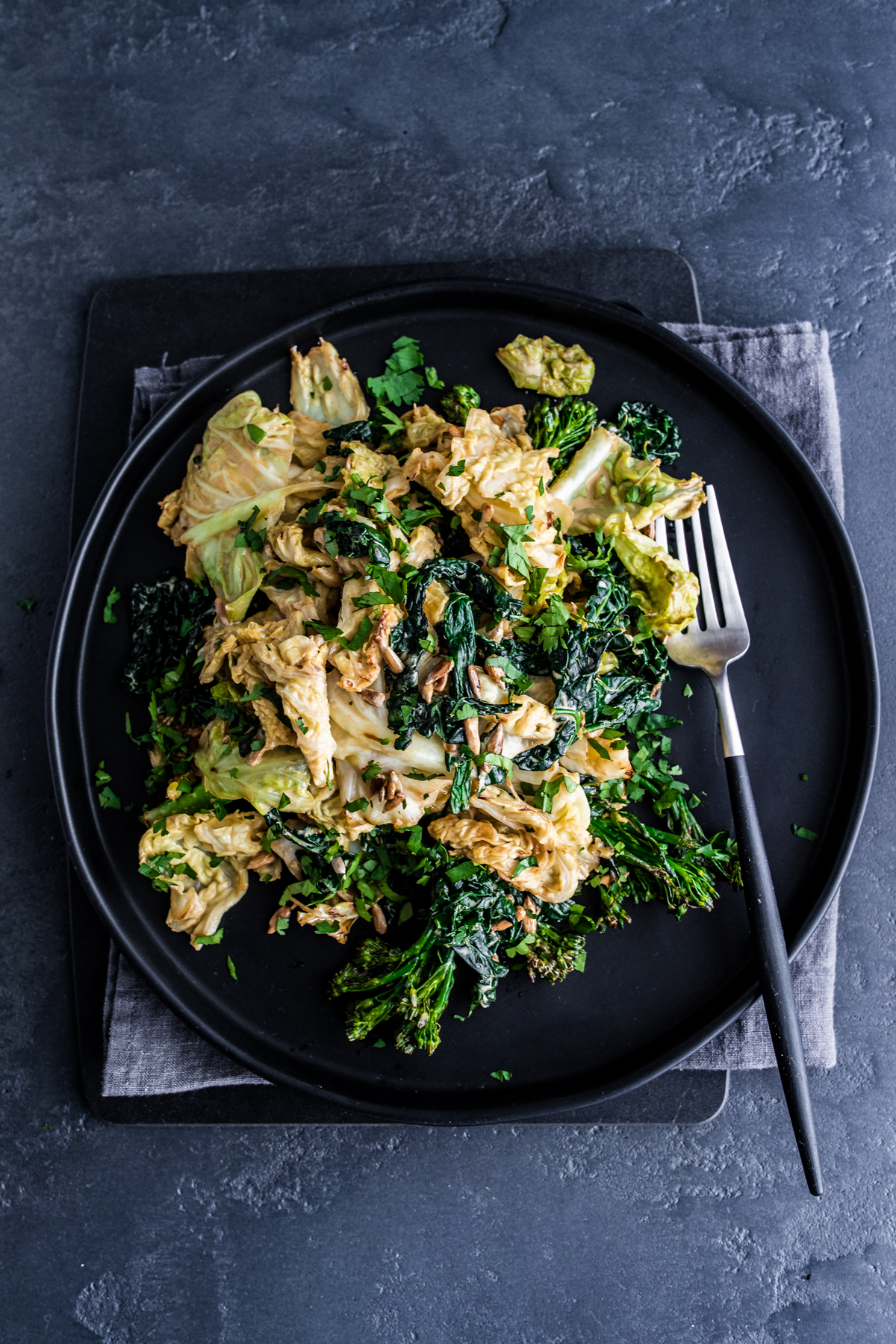 Broccoli rabe salad on a black plate