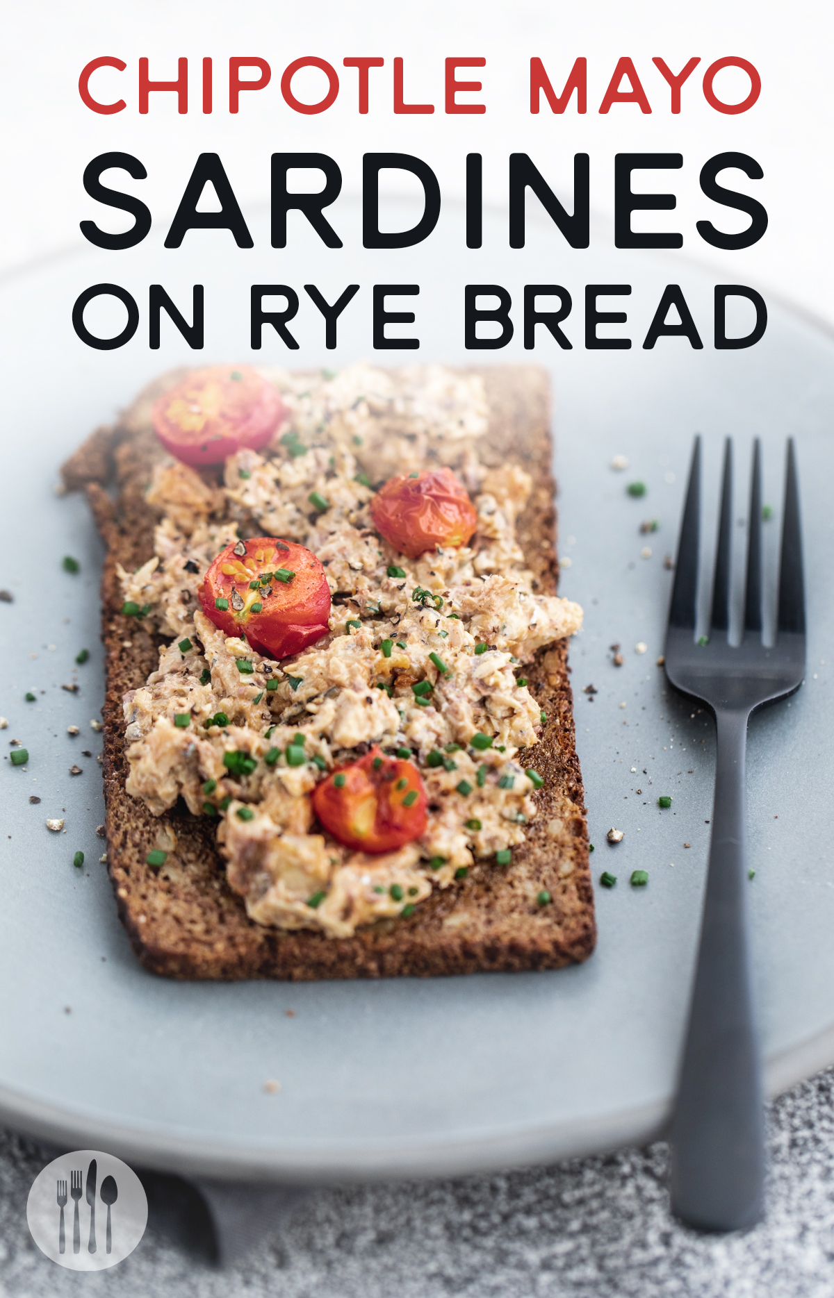 Open faced sardine mayo sandwich on rye bread on a blue plate with a black fork