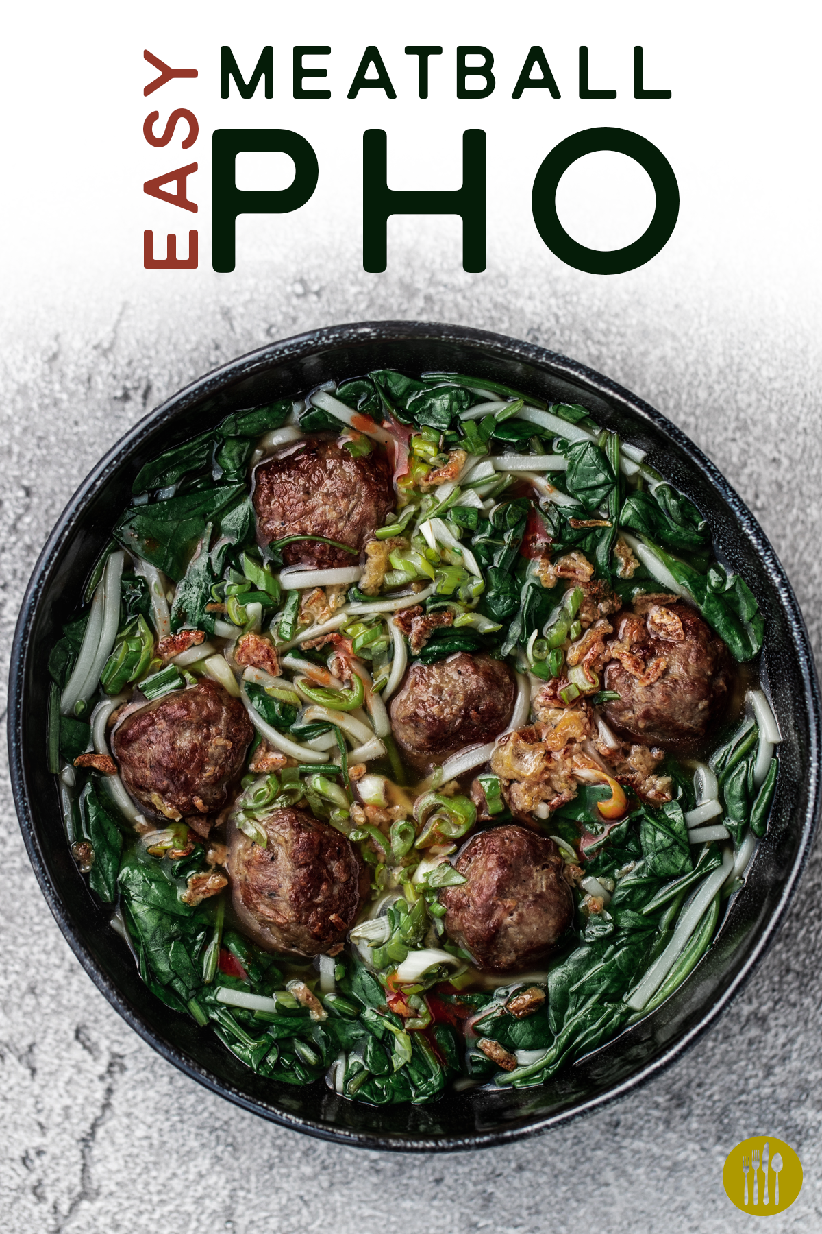 A bowl of easy meatball pho in a black bowl on a grey background