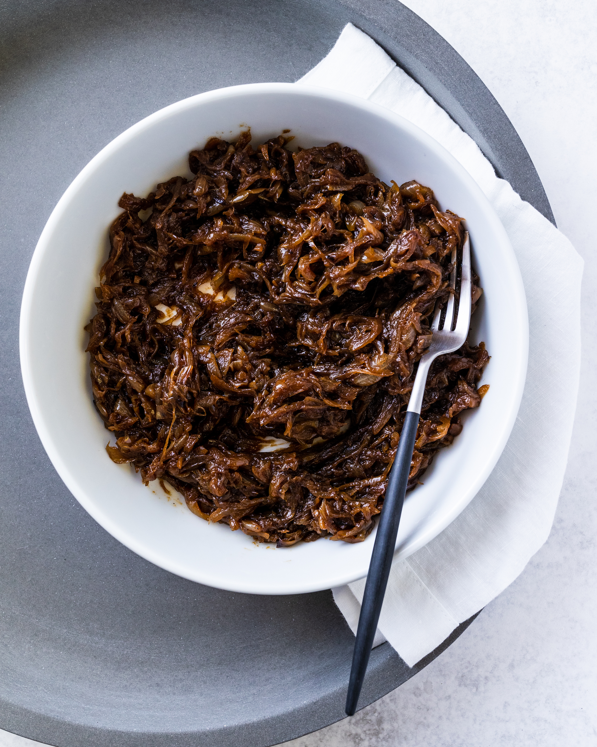 Caramelised Onion in a white bowl on a grey platter