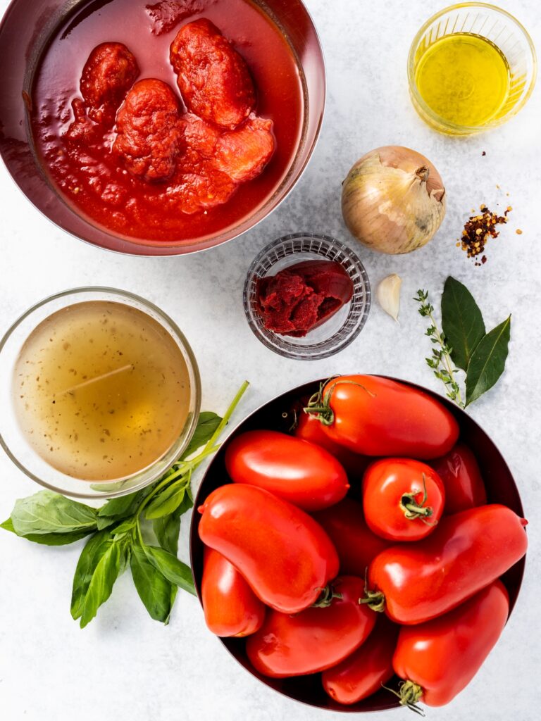 Homemade tomato sauce ingredients on a white background