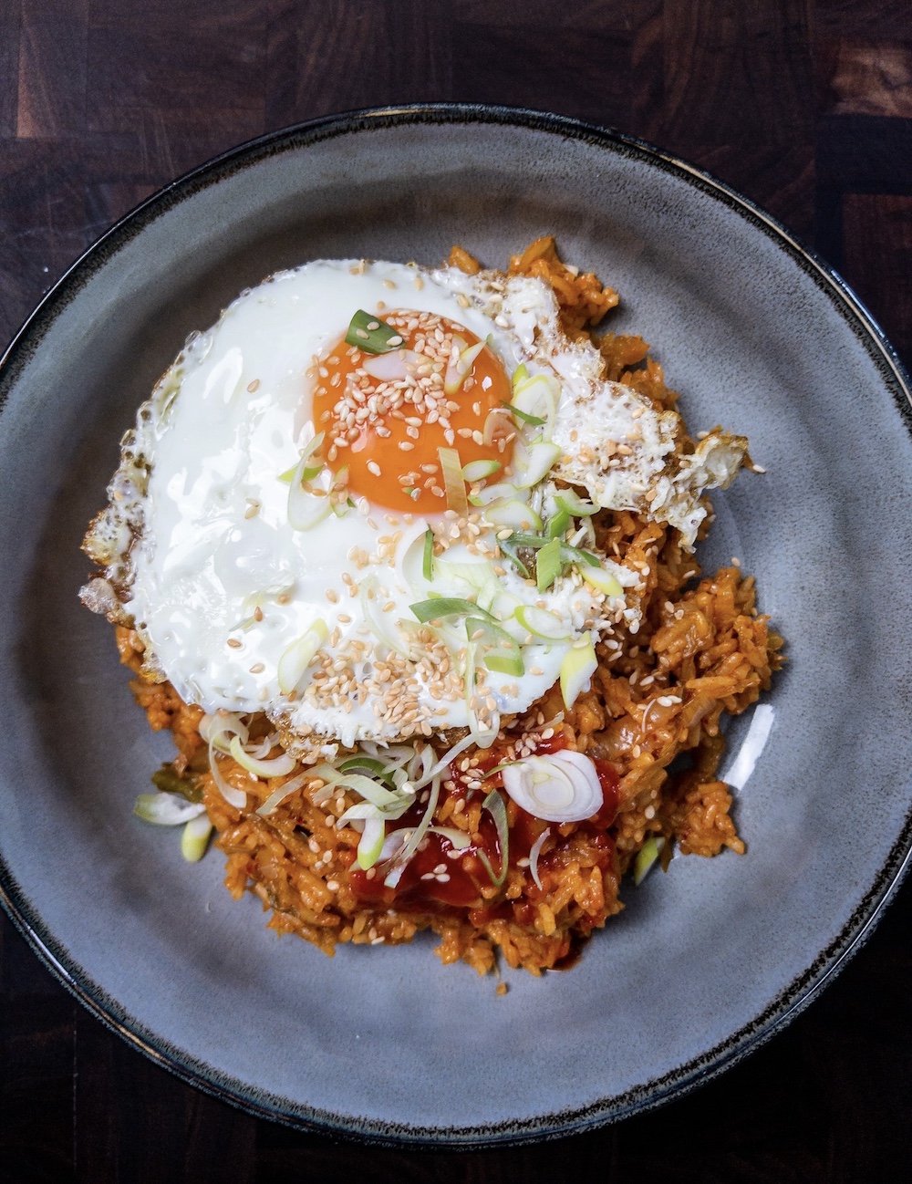 Overhead shot of kimchi fried rice with a fried egg on top