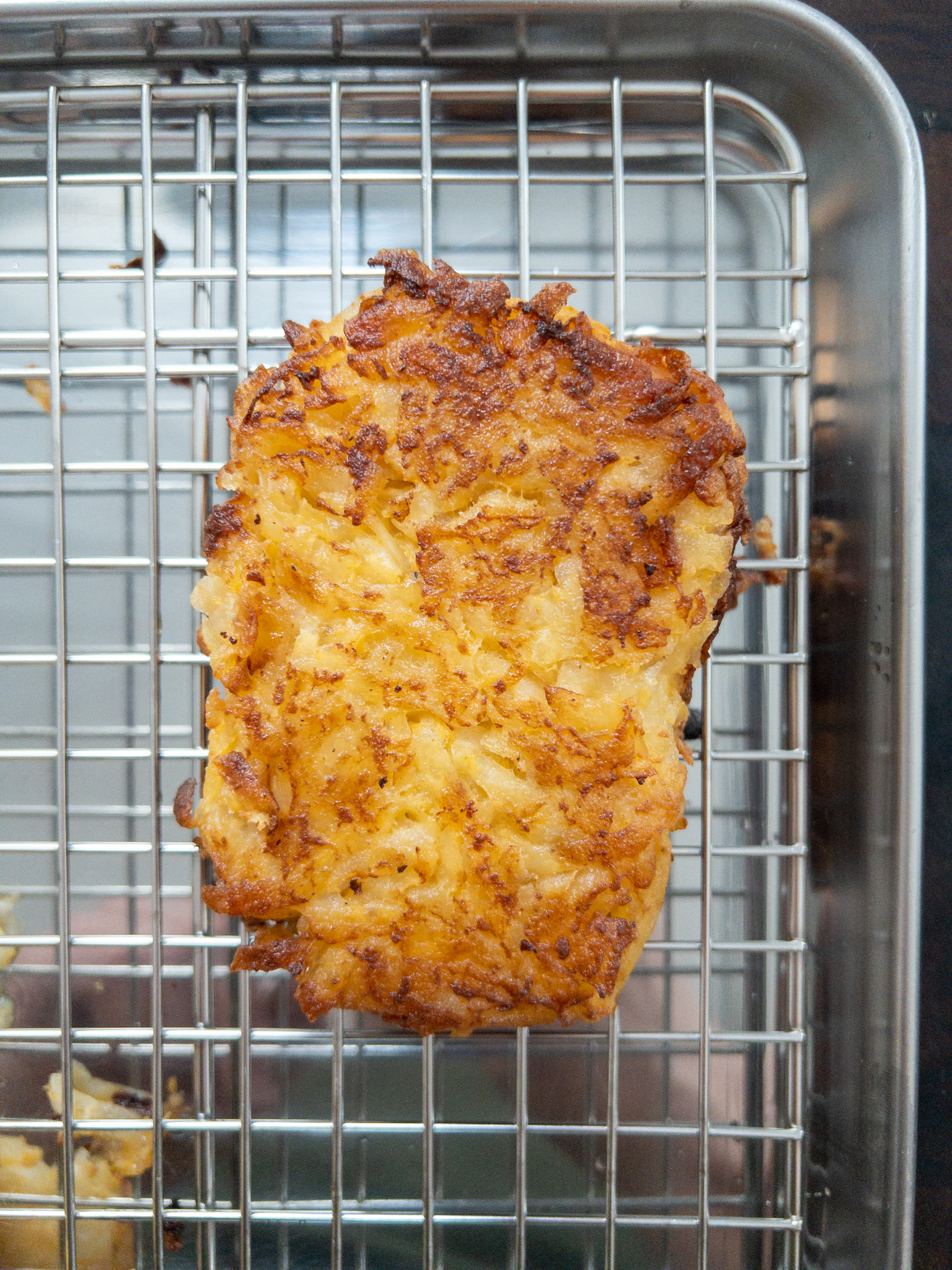Overhead shot of a home made hash brown on a wire rack