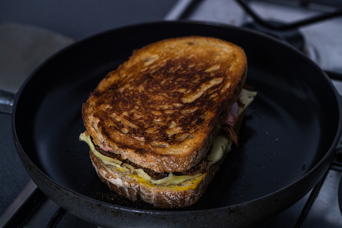 Cubano sandwich in a pan with the browned side showing