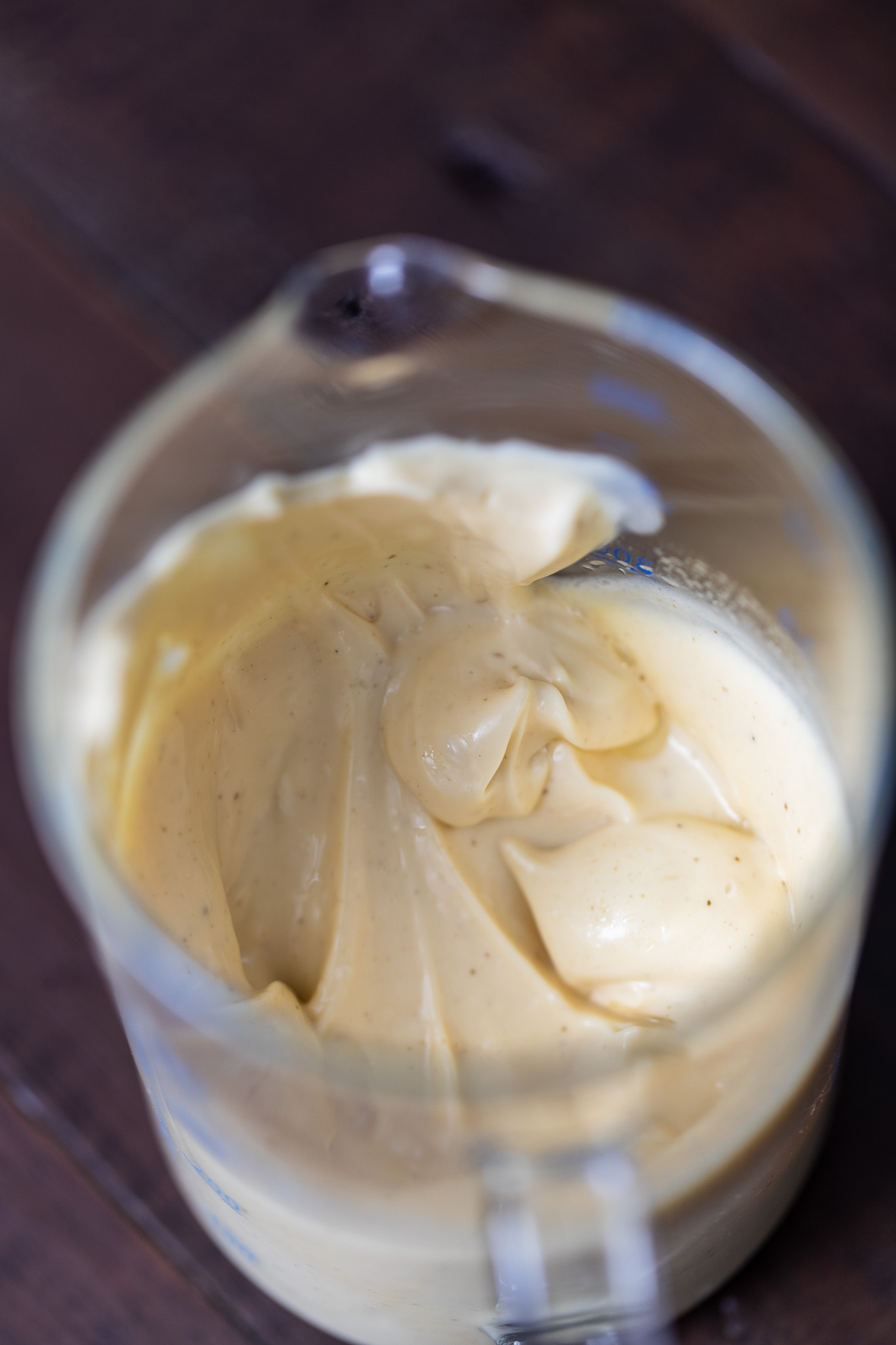 Overhead shot of homemade mayo in a stick blender jug