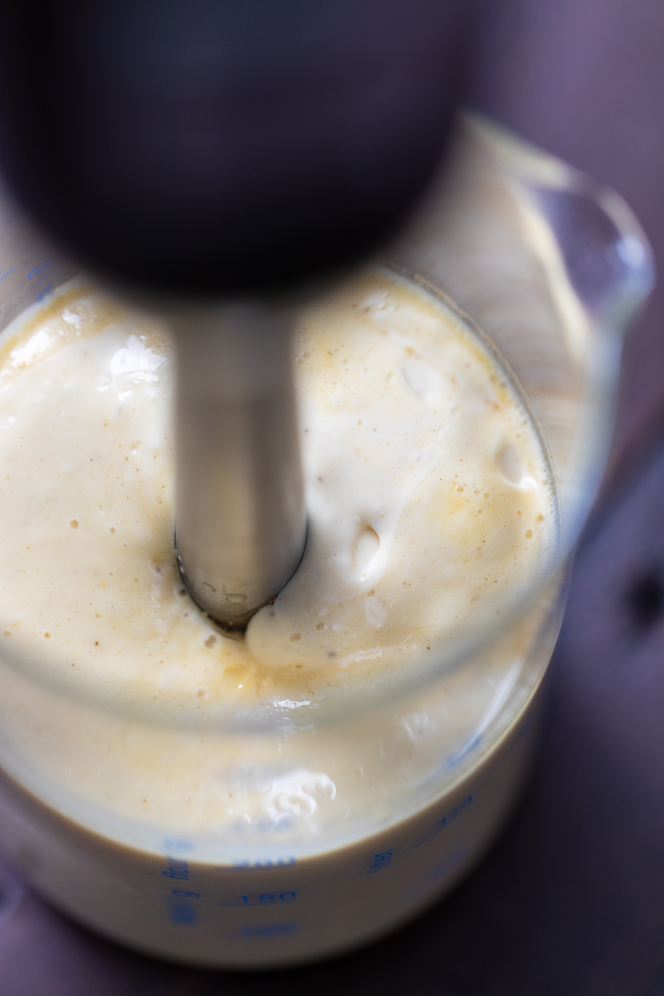 Overhead shot of homemade mayo being blended with a stick blender